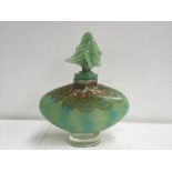 An Art Glass decanter and stopper, green and brown glitter glass with spots of turquoise,