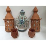 A collection of terracotta wall lanterns and a candle holder together with a stoneware ewer with