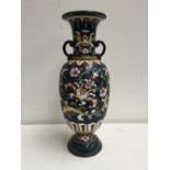 A ceramic vase with loops handles of colourful floral design over blue ground 40 cm