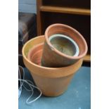 A quantity of terracotta plant pots of various sizes