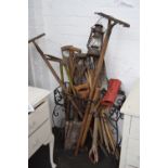 A quantity of vintage garden tools including rakes, shovel, forks, sledge hammer, shears,