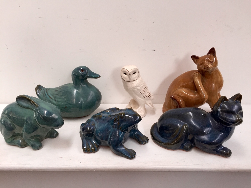 A selection of ceramics glazed animals including two cats, one frog, one bunny,