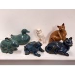 A selection of ceramics glazed animals including two cats, one frog, one bunny,