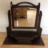 An oak toilet mirror over single short drawer