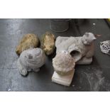 Three composite stone garden scuptures of cats together with a stone acorn