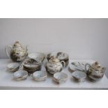 A Japanese egg shell porcelain part tea set decorated in typical palette with flora and fauna