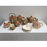 A Beswick cottage pottery set including: a teapot, coffee pot, sugar bowl, milk jug, biscuit jar,