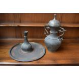 An Indian brass urn with stylise loop handles 46 cm height together with a plate and vase of