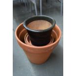 Nine terracotta plant pots in various sizes