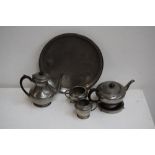 A collection of pewter items including an early 20th century pewter teaset, tray sugar bowl etc.