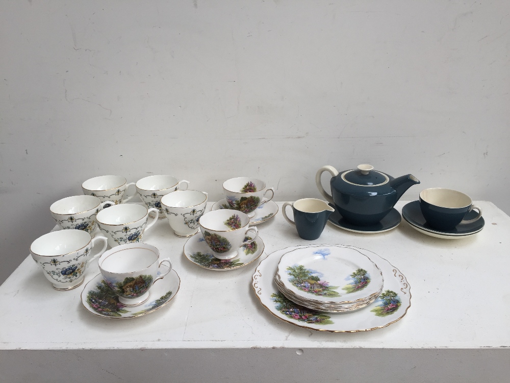 A teal colour Poole pottery set including a tea cup, two side plate, a milk jug and a tea pot,