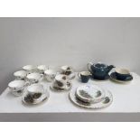 A teal colour Poole pottery set including a tea cup, two side plate, a milk jug and a tea pot,