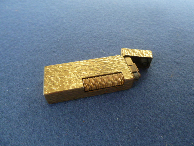 A Dunhill gold plated bark textured lighter 6.5 x 2.