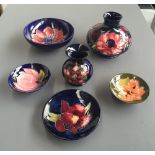 A selection of six pieces of Moorcroft pottery including two vases and four small trinket dishes,