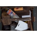 A box of tools including a wooden mallet, a plaster trowel, hammers,