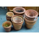 A large quantity of terracotta plant pots of various sizes