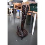 A dragon carved hardwood floor lamp, carved base raised upon three clawed feet, in three part,