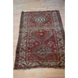 A Caucasian prayer rug, with red fields,