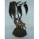 An interesting spelter and silverplate table centre depicting a red stag beneath palm trees