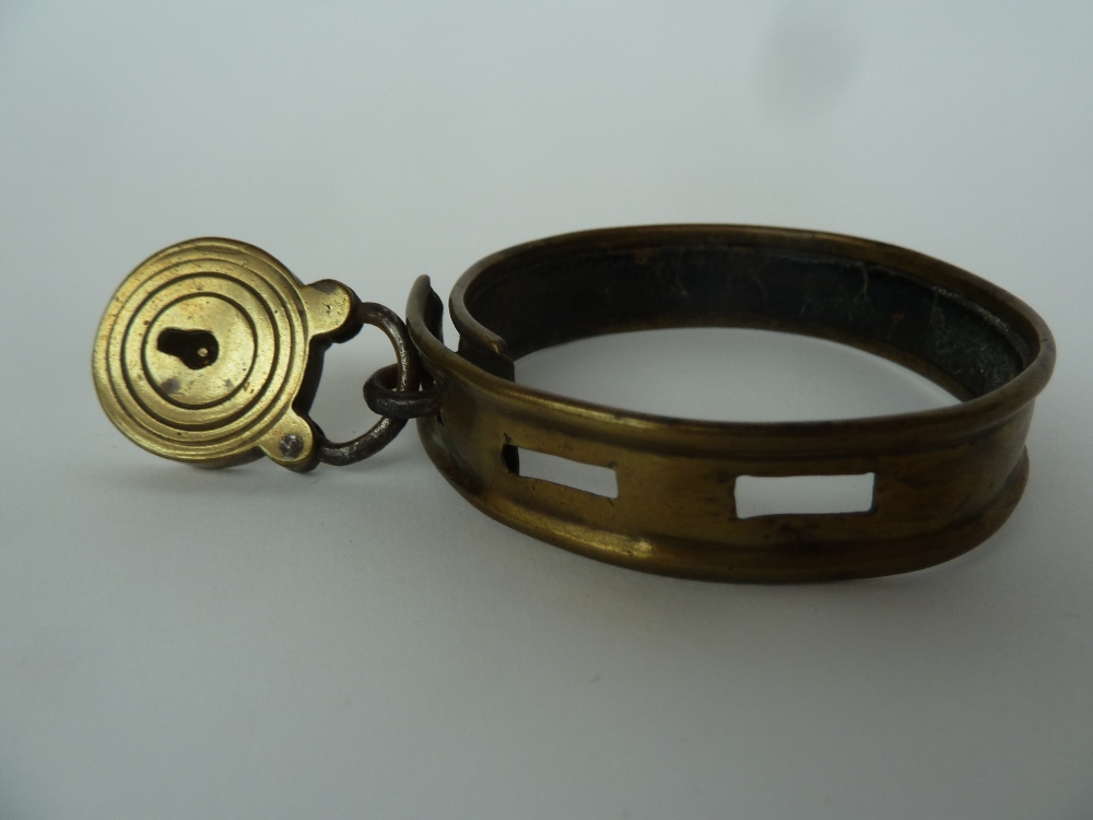 A Victorian brass dog collar with padlock approximately 6cm diameter