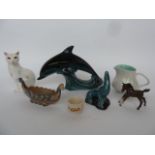 A set of Poole pottery including two meat platters, a cat, a dolphin, a seal,