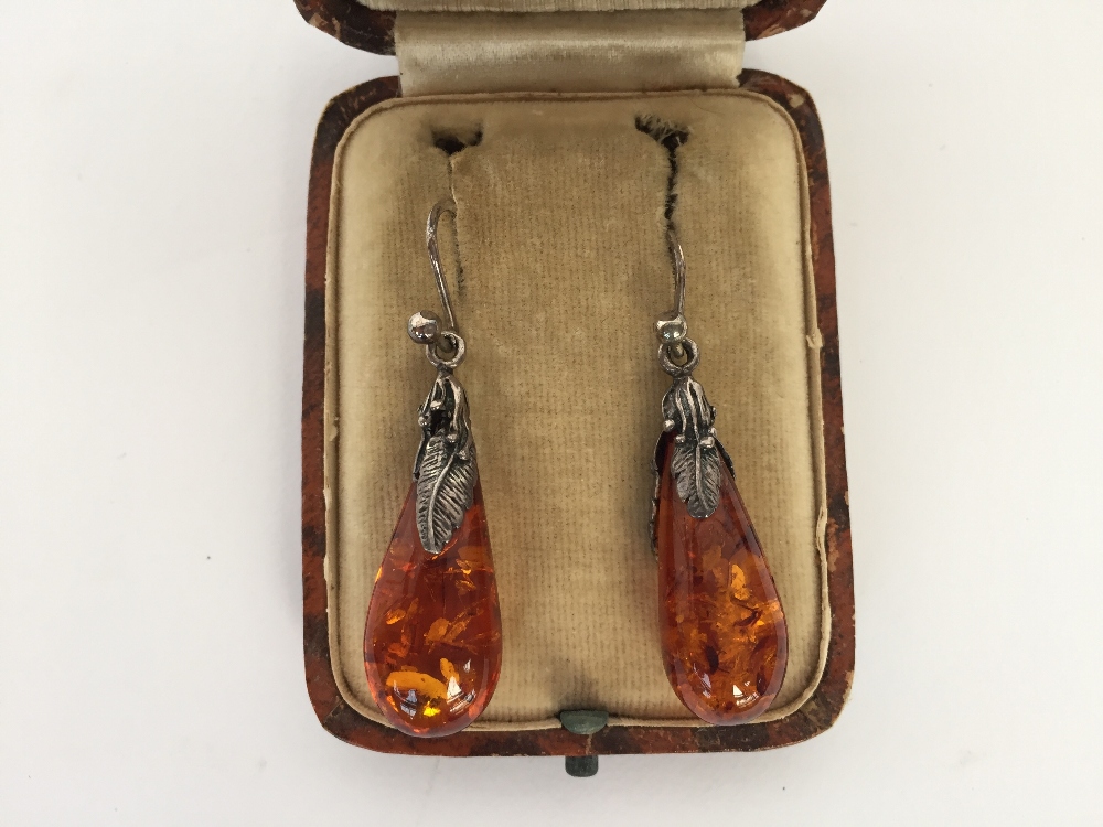 A pair of amber and silver teardrop earrings