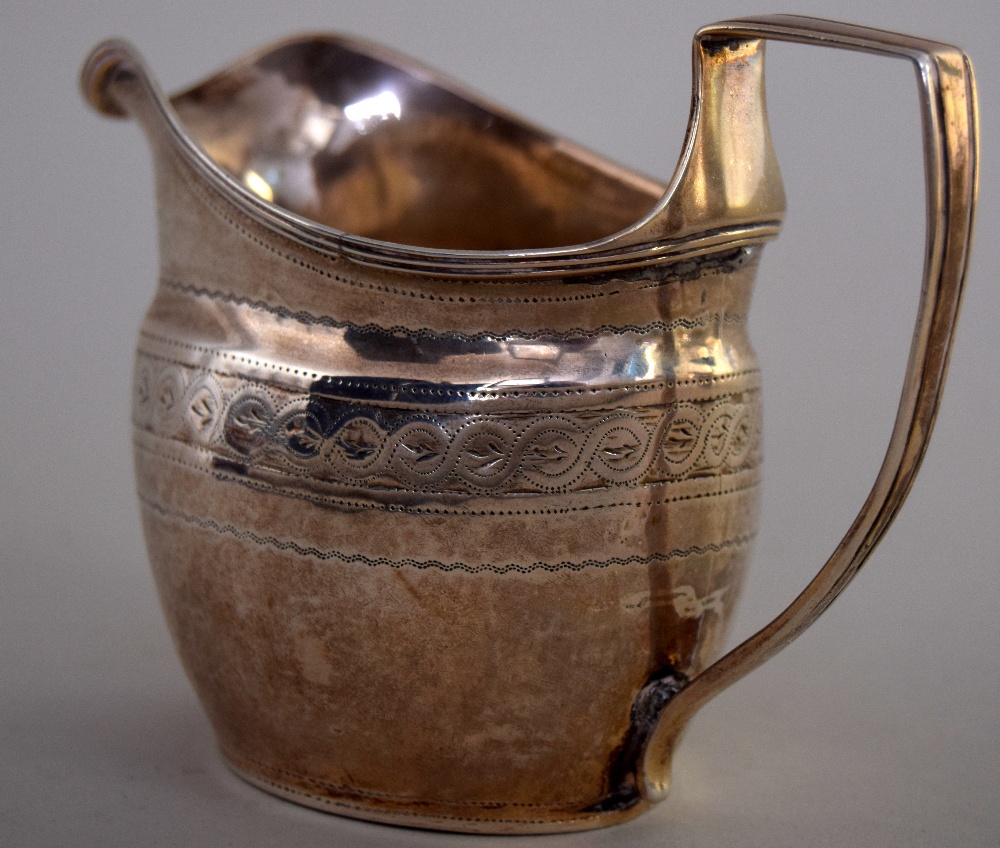 A George III silver cream jug, London 1805, with weave engraving, 9cmH, 2.