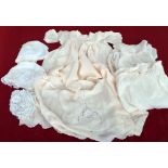 A box of antique fine lawn cotton Christening robes and one silk, six in total,