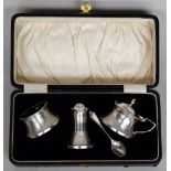 A cased silver and Bakelite cruet set comprising salt, pepper and a mustard pot with spoon ,