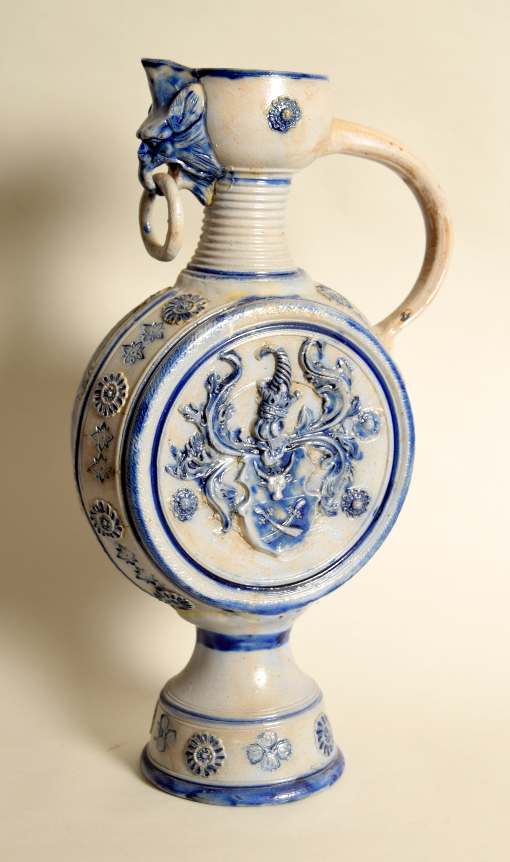 A German salt glaze stoneware moonflask with loop handle and griffin spout,