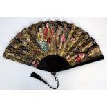 A large ebony Victorian fan depicting a loving couple with dancing dog and musician 37cmL closed