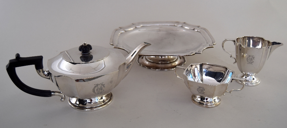 An Art Deco style tea service with rounded cut out corner and ebonised handle and finial including