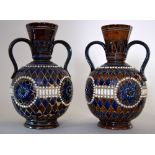 Two Royal Doulton Lambeth stoneware twin handled vases decorated with a geometric design in blue