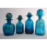 Four Mdina decanters and stoppers, of blue and yellow design, in various sizes,