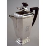 An Art Deco style coffee pot of faceted rectangular shape with cut out corner raised on octagonal
