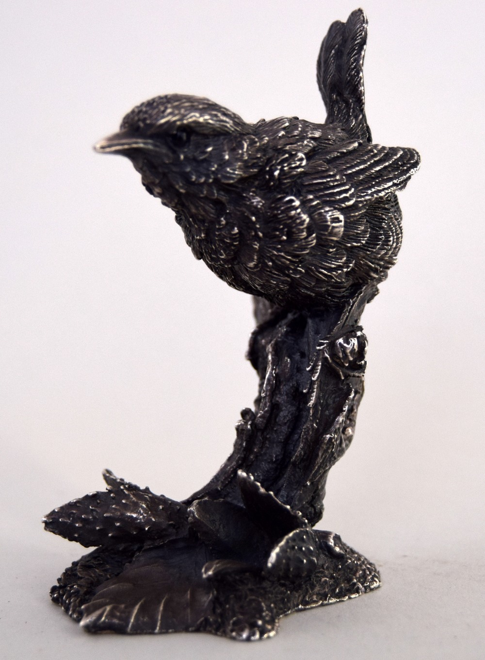 A silver naturalistic model of a wren perched on a branch, maker 'CA' 1991 Birmingham,