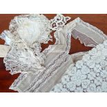 A large mixed box of mostly Victorian lace trimmings, dress parts, cut work pieces and table ware.