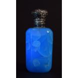 A Victorian turquoise glass and white metal mounted scent bottle with foliate hinged top,