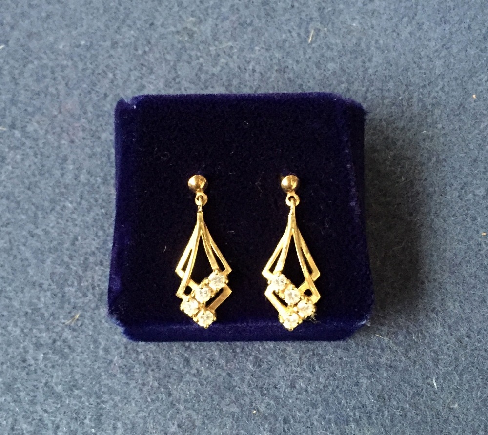 A pair of gold plated drop down earring with four small zirconia each