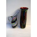 Two large pieces of multicoloured art glass including a water jug with striped black, blue,