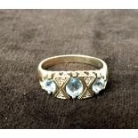 A 9ct gold ring with three pale blue stones