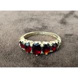 A 9ct gold ring with five red stones
