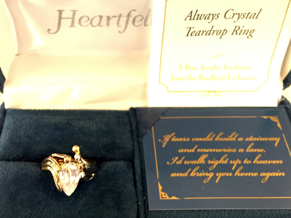 A 925 silver Always Crystal Teardrop Ring with certificate together with a heart shape locket with