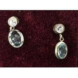 A 9ct pair of pendant earrings with zirconia and pale blue stones