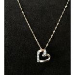 A 9ct gold chain with a heart shape pendant decorated with five diamonds