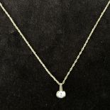 A 9ct gold chain with a round zirconia pendant