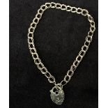 A 9ct double link chain with a heart shape lock pendant