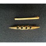 A 9ct gold brooch together with another yellow metal brooch