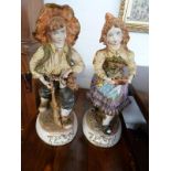 Pair of Capo Di Monte decorated figures modelled as young farm workers (slight damage to both