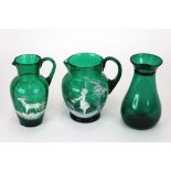 A green glass baluster shaped jug,